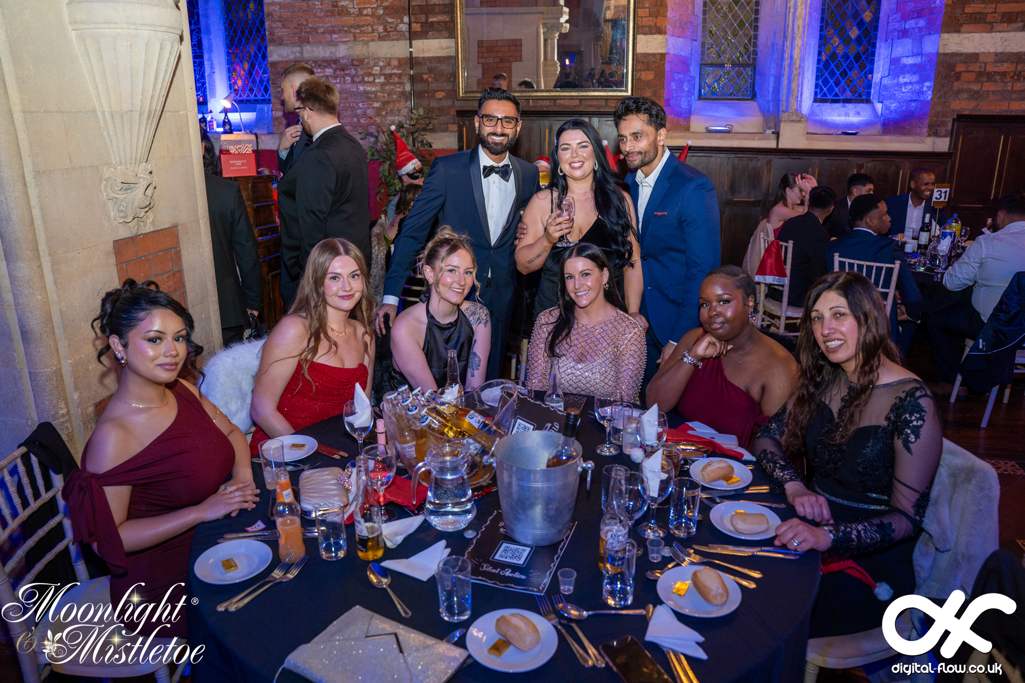 A team group at their reserved dinner table at a Moonlight & Mistletoe Christmas party night at Empire Banqueting Hall Leicester